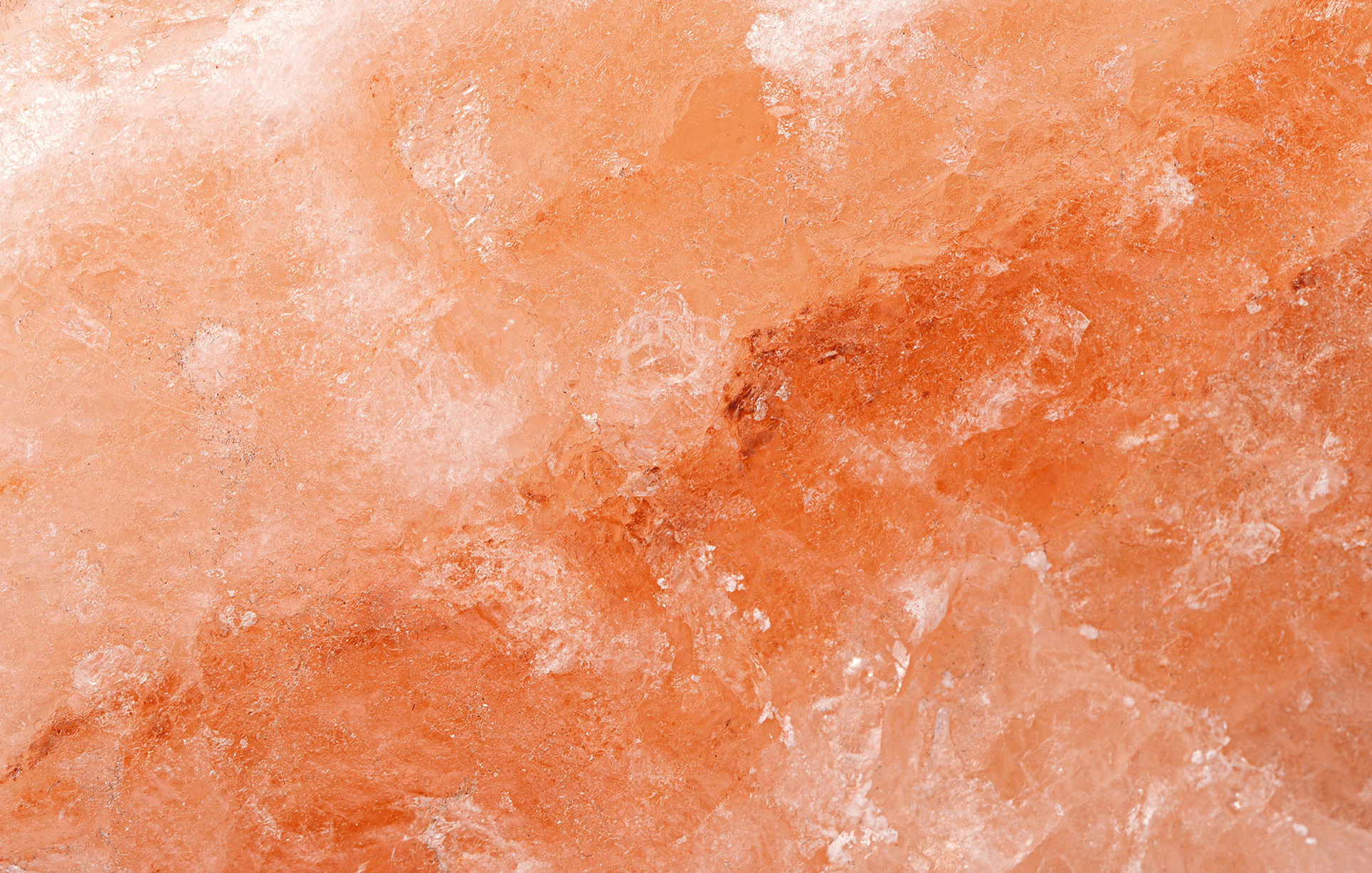 Himalayan block salt surface. Natural huge crystal Pakistani pink orange salt background, top view